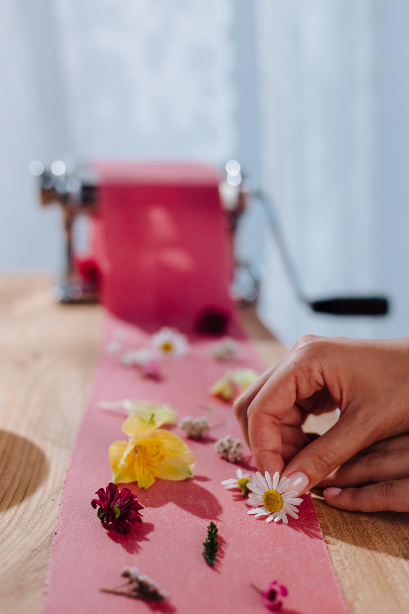 artisan at work embroidering a floral motif